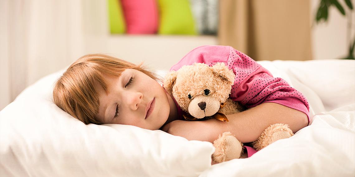 red hair little girl sleeping in bed